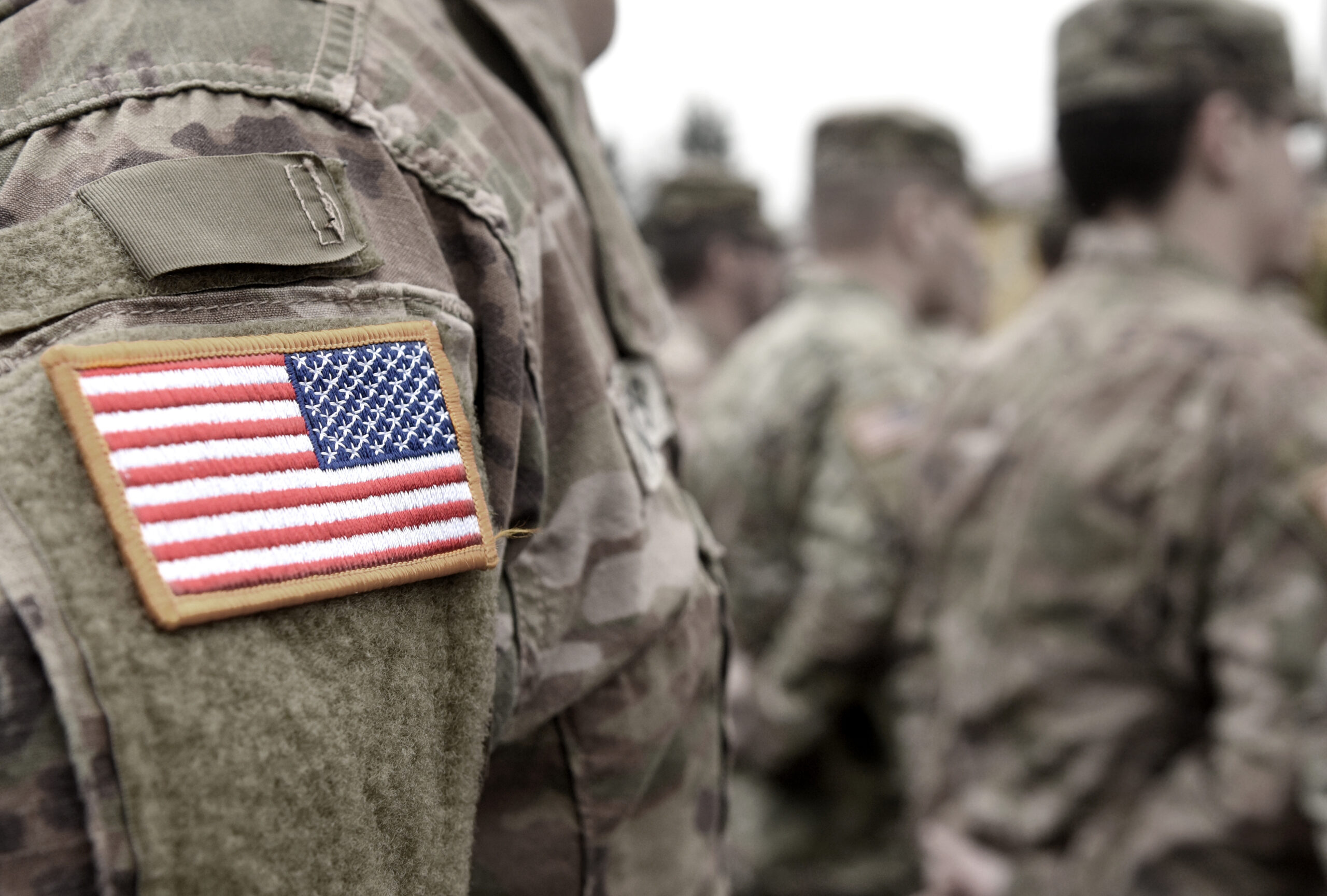 U.S. military service members in formation — estate planning for veterans in Virginia requires special consideration of VA benefits, survivor pay, and federal insurance rules