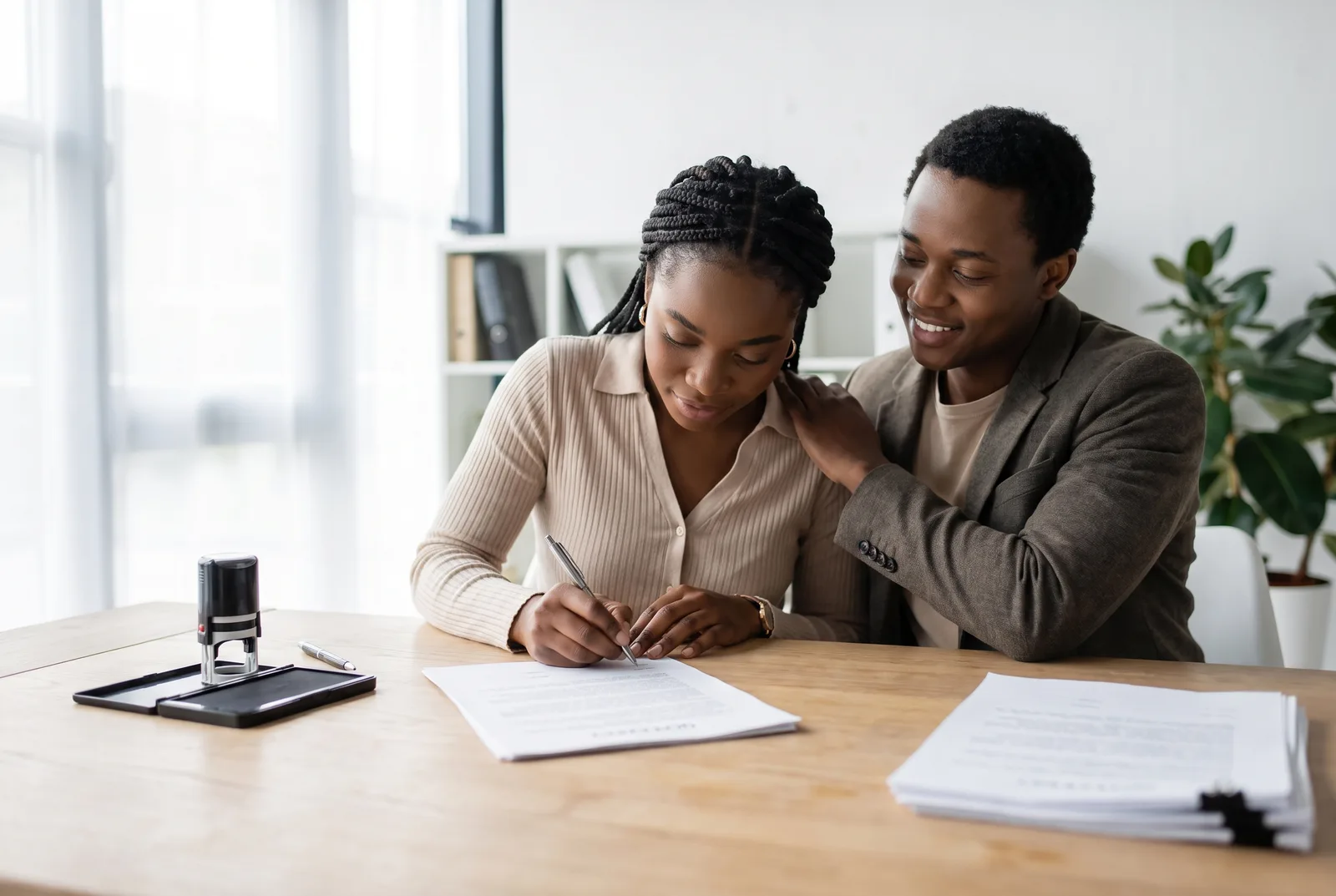 A couple signing and notarizing a Virginia prenuptial agreement well before their wedding