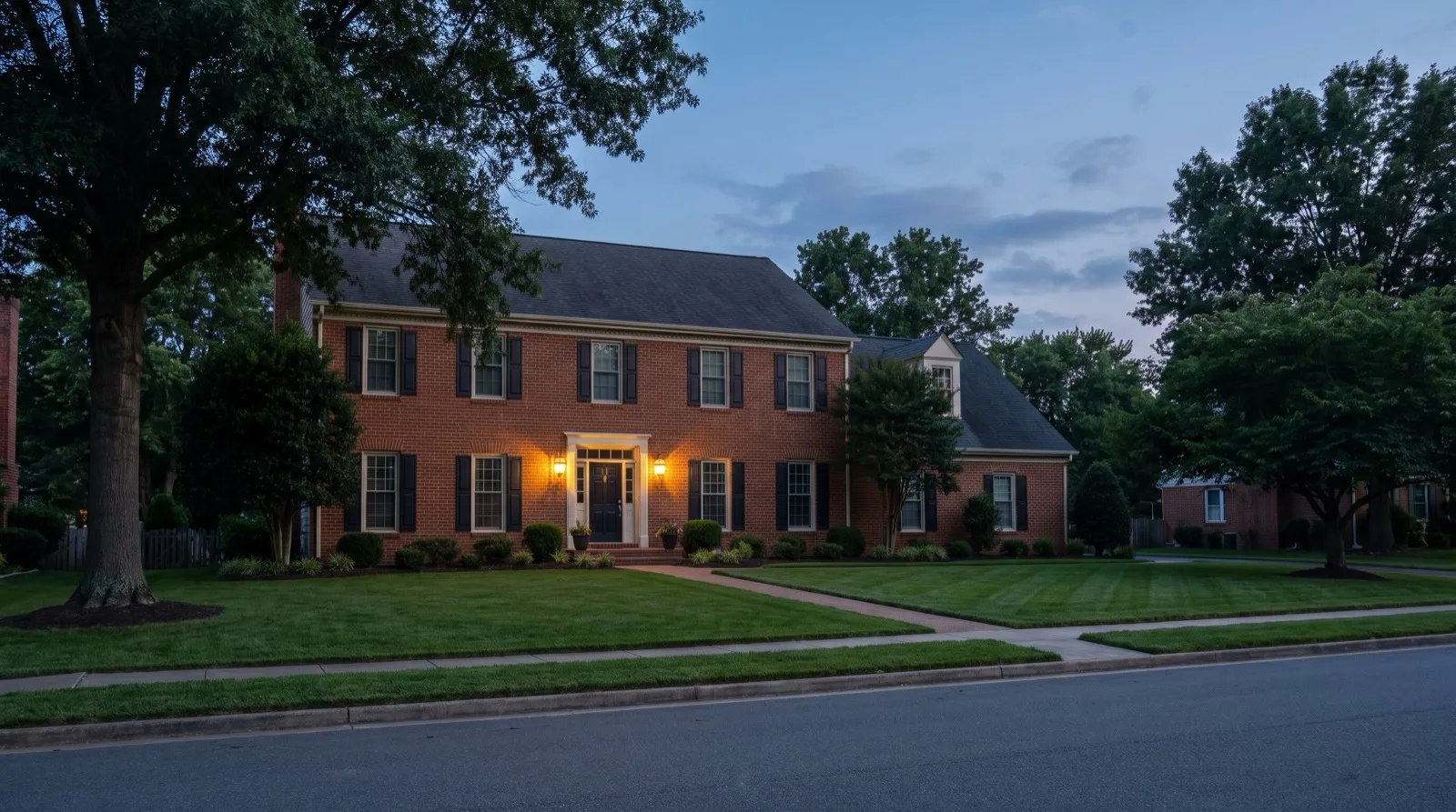 Brick Virginia home at dusk with the porch light on, illustrating the castle doctrine